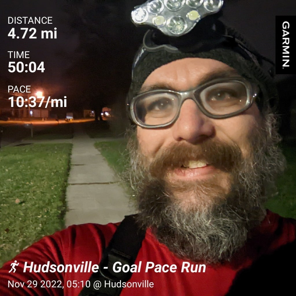 Distance: 4.72 miles, Time: 50:04, Pace: 10:37 min/mile | Hudsonville - Goal Pace Run | Garmin / Selfie of me with street lights lighting up the sidewalk & street in our neighborhood after my run.
