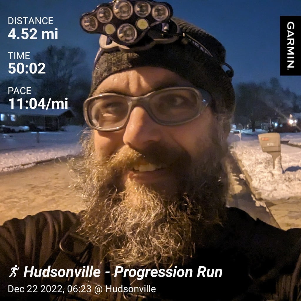 Distance: 4.52 miles, Time: 50:02, Pace: 11:04 min/mile | Hudsonville - Progressive Run / Me early in the morning on the street outside my home with the snowy yards in the background.
