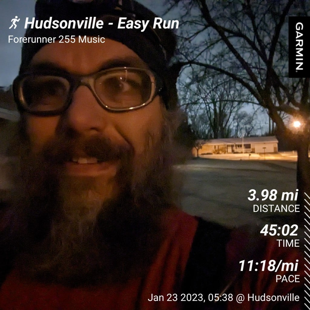 Hudsonville - Easy Run | Distance: 3.98 miles, Time: 45:02, Pace: 11:18 min/mile / Early morning run selfie in the driveway with snowy grass and street lights in the background.